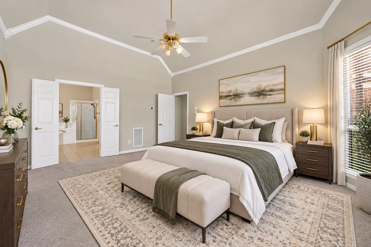 Vaulted ceiling with crown molding, double pane windows, ceiling fan, and double doors opening to an adjacent room