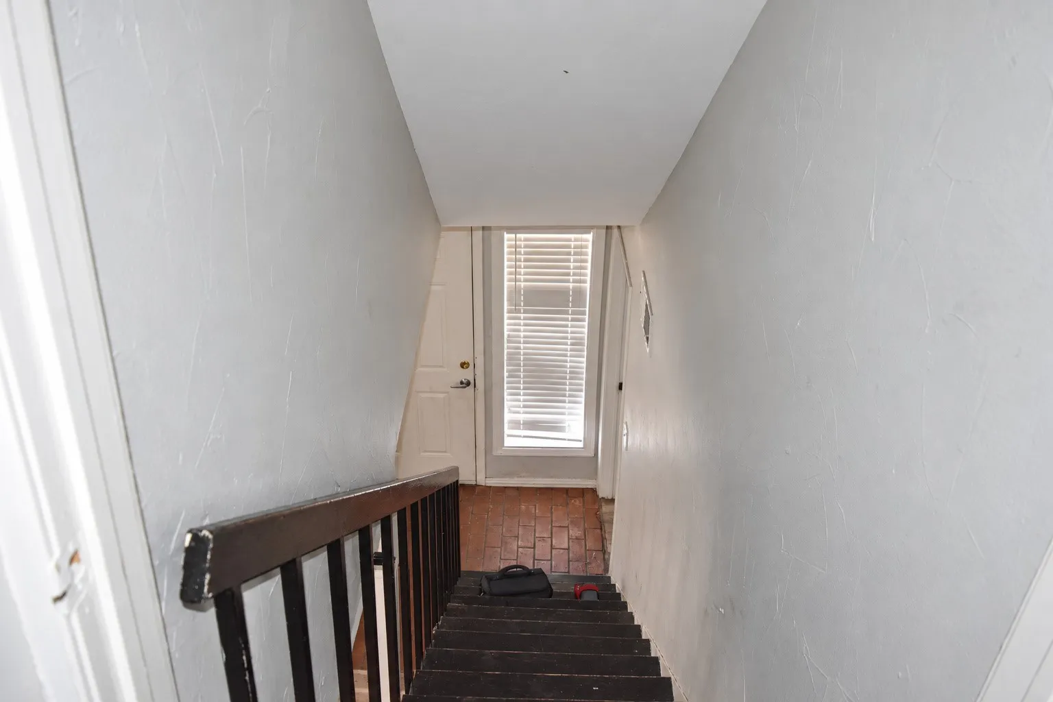Staircase with wood treads and a dark wood handrail