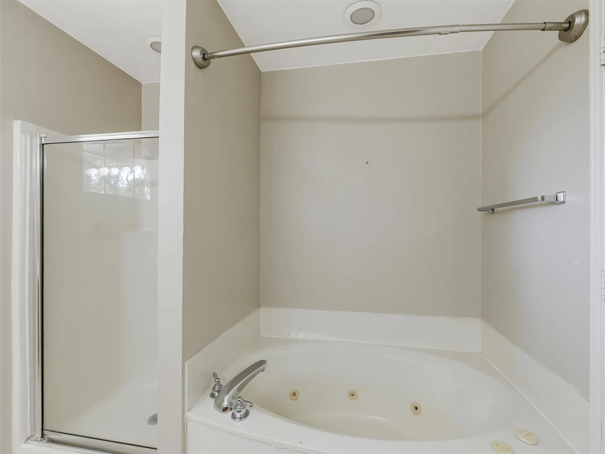 Soaking tub with integrated jets and a separate glass-enclosed shower