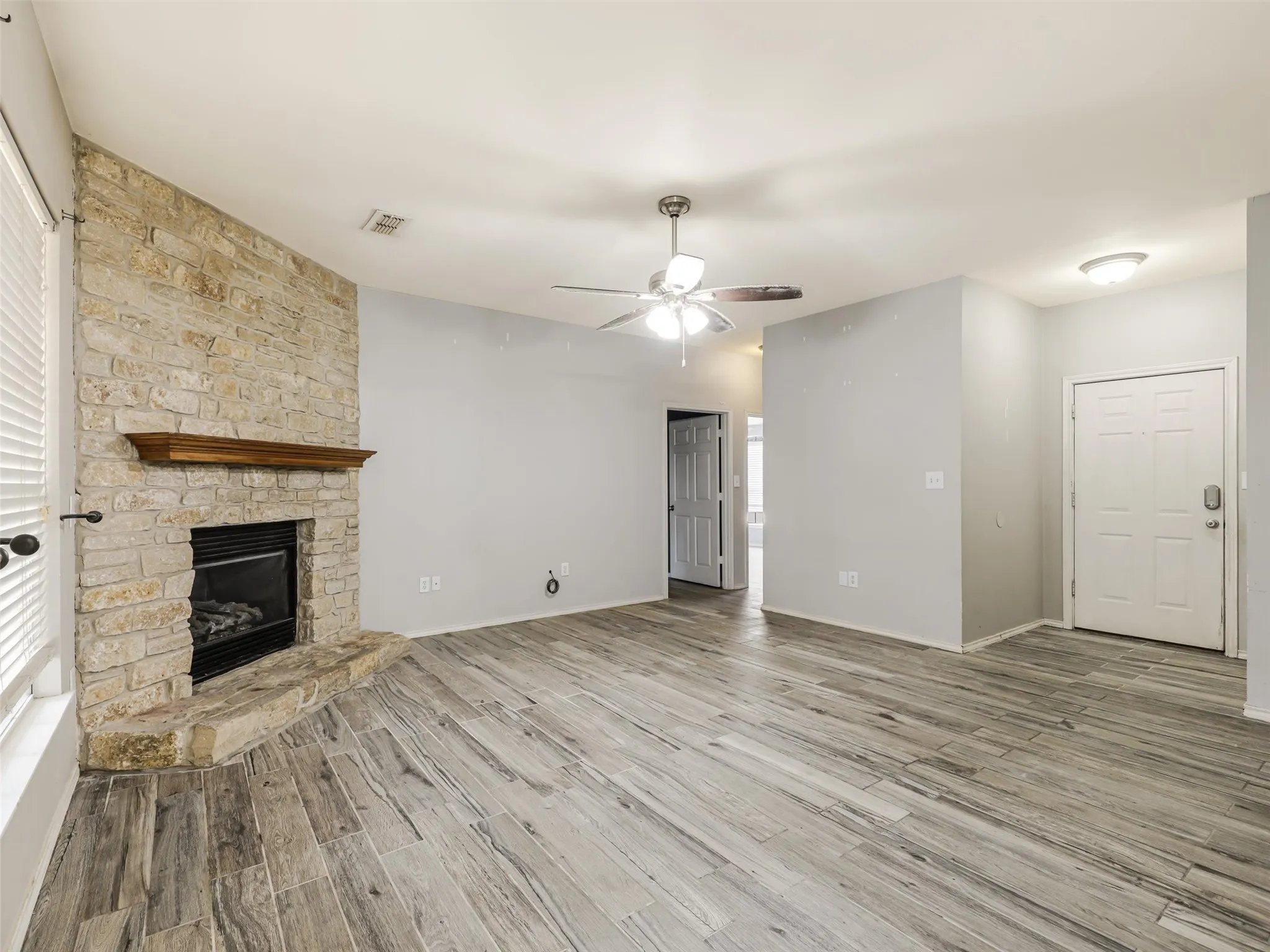 Stone-faced fireplace with a wood mantel