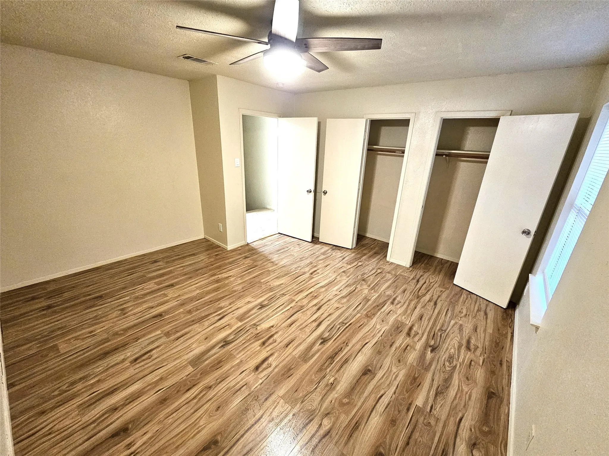 Bedroom#2-Another good size bedroom (13x13) with new ceiling fan & new wood laminate floor. And with double closets as well. (unit C)