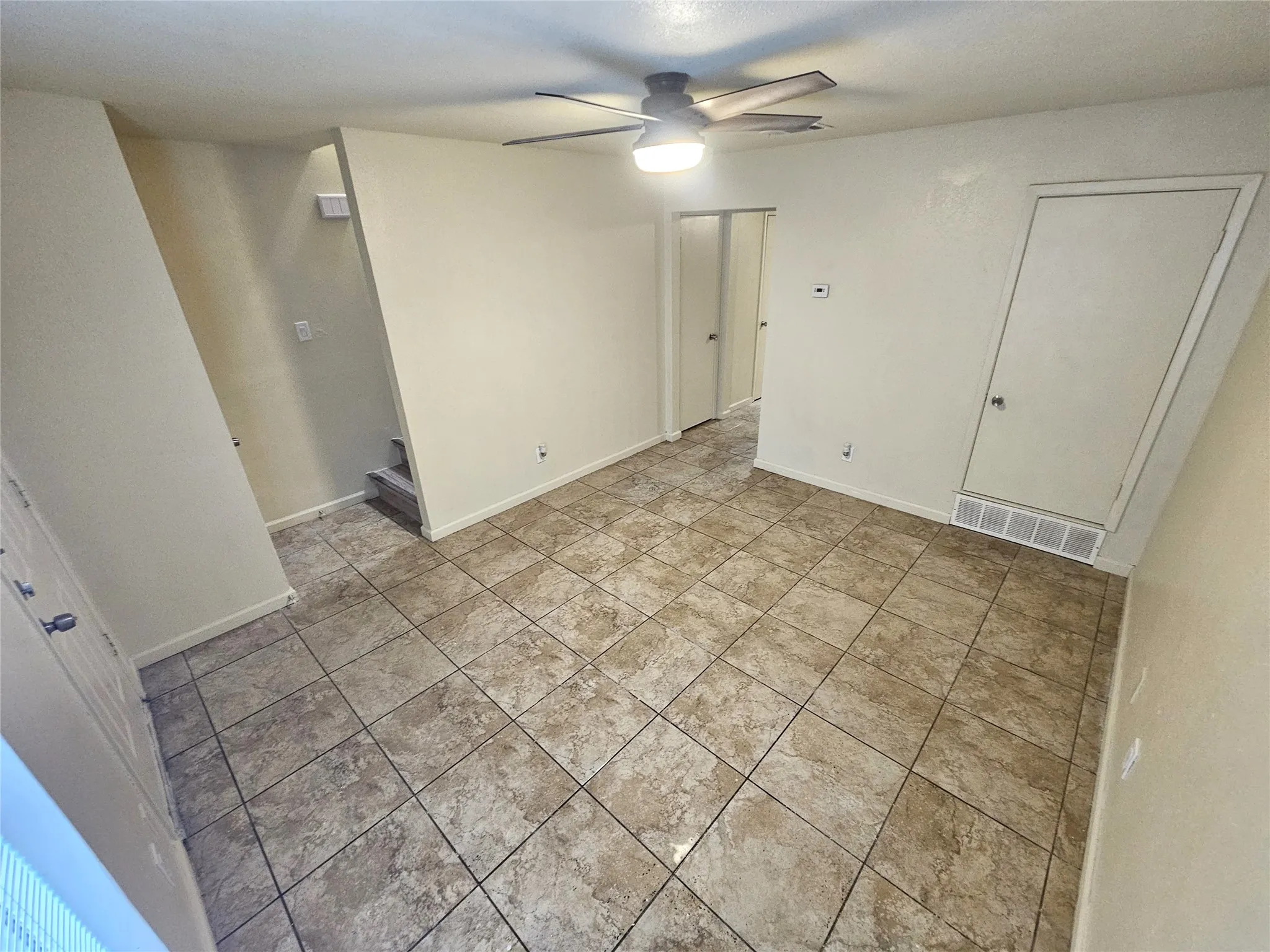 Family/Living room with new fresh paint and new ceiling fan. (unit C)