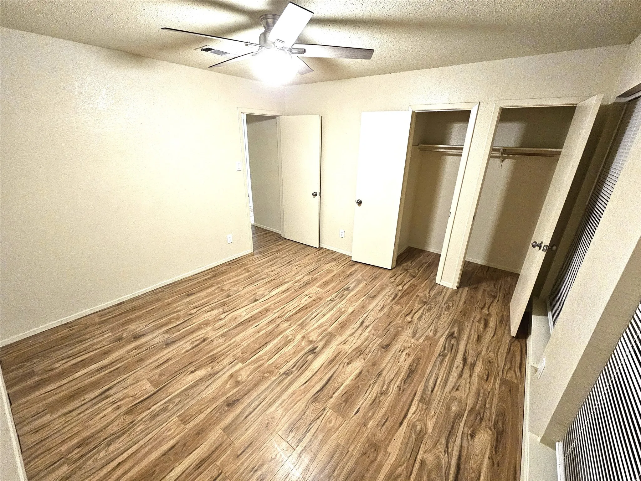 Bedroom #1-spacious bedroom (13x13) with new modern ceiling fan & wood laminate flooring - no carpet in this townhome. Stairs is wood laminate as well. (unit B)