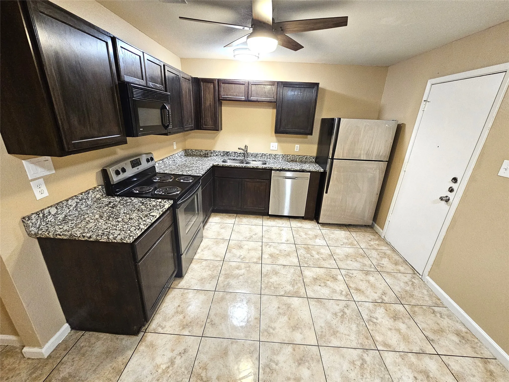 Newlly remodeled kitchen with lots of newly installed cabinets, new modern ceiling fan, modern light. New sink and faucet, new cabinets, granite countertop. new appliances. (unit D)