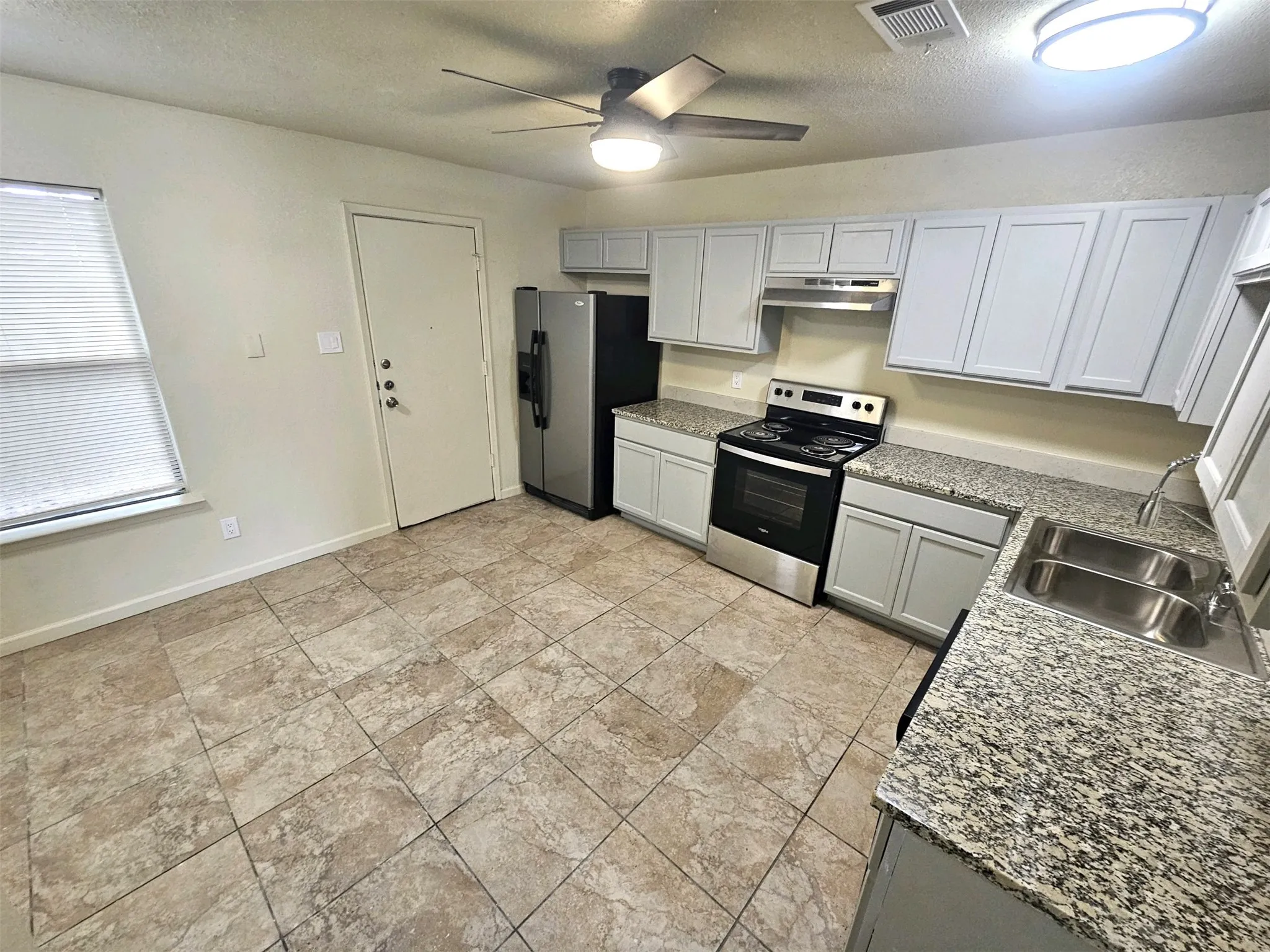 Newlly remodeled kitchen with lots of newly installed cabinets, new modern ceiling fan, modern light. New sink and faucet, new cabinets, granite countertop. new appliances. (unit C)