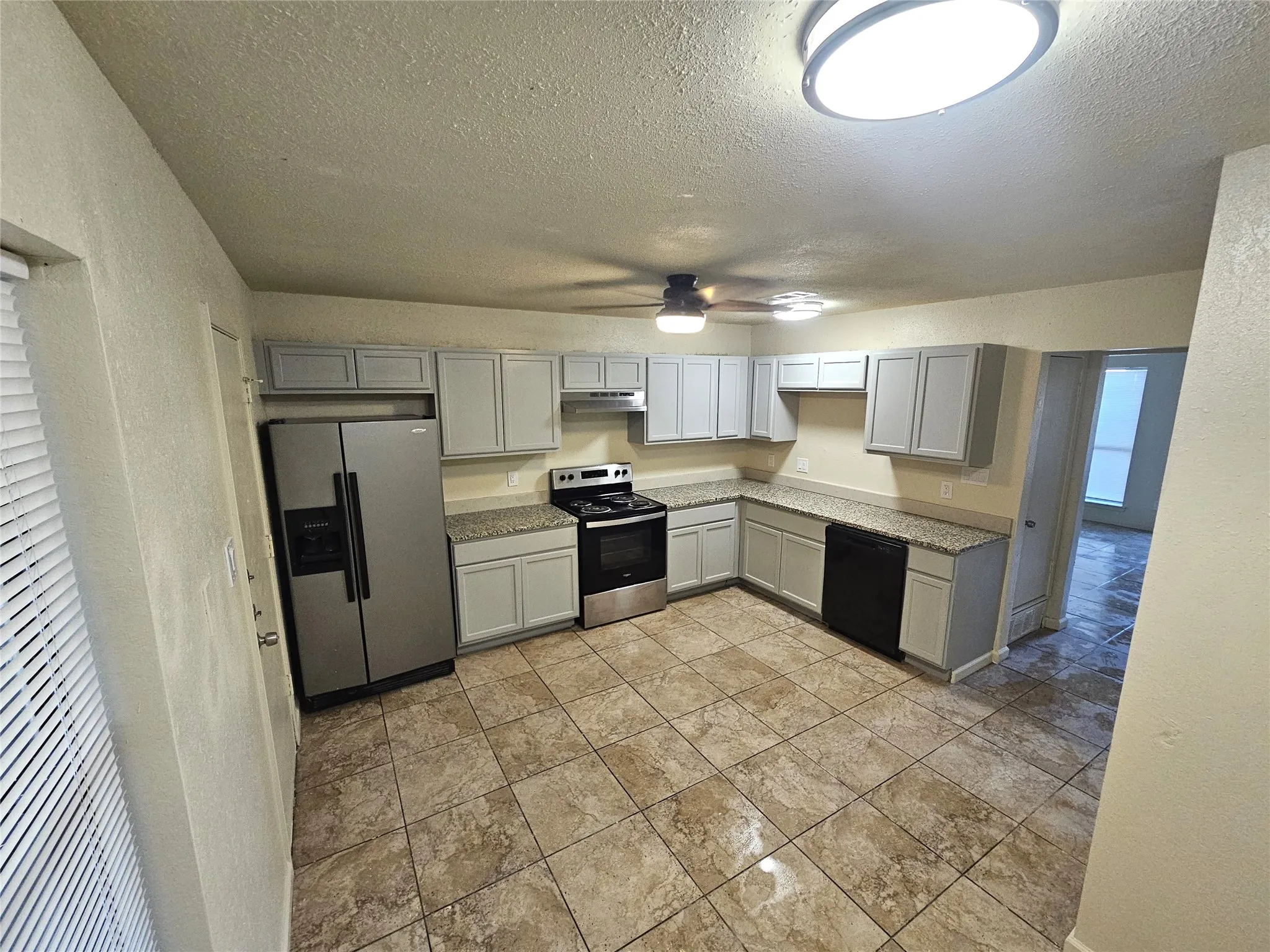 Newlly remodeled kitchen with lots of newly installed cabinets, new modern ceiling fan, modern light. New sink and faucet, new cabinets, granite countertop. new appliances. (unit C)