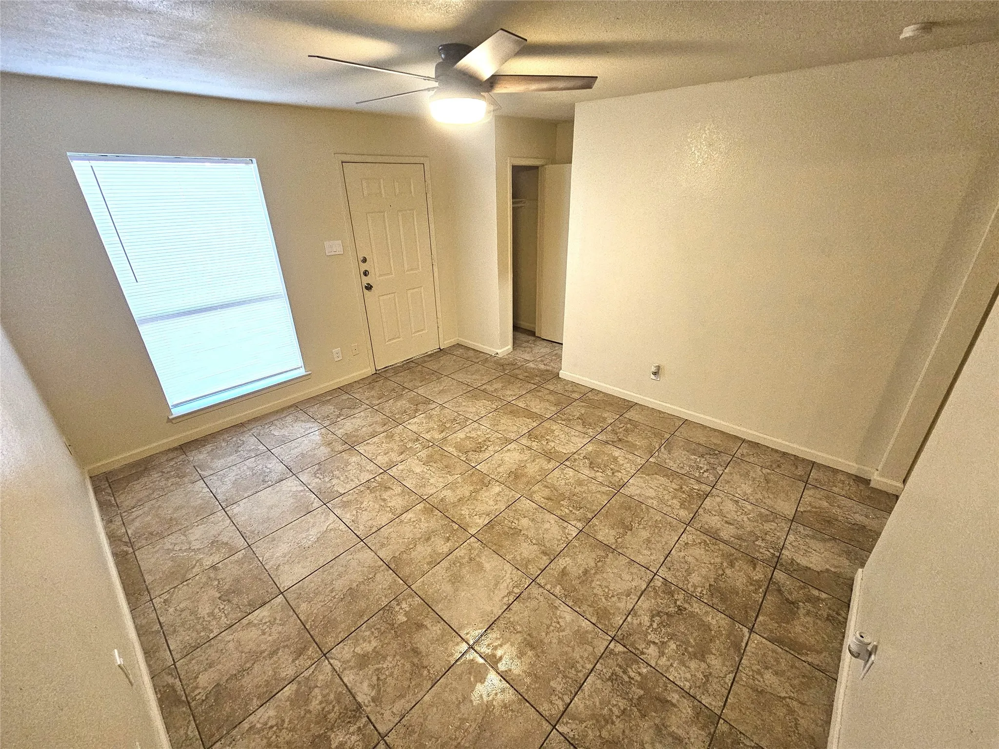 Family/Living room with new fresh paint and new ceiling fan. (unit C)