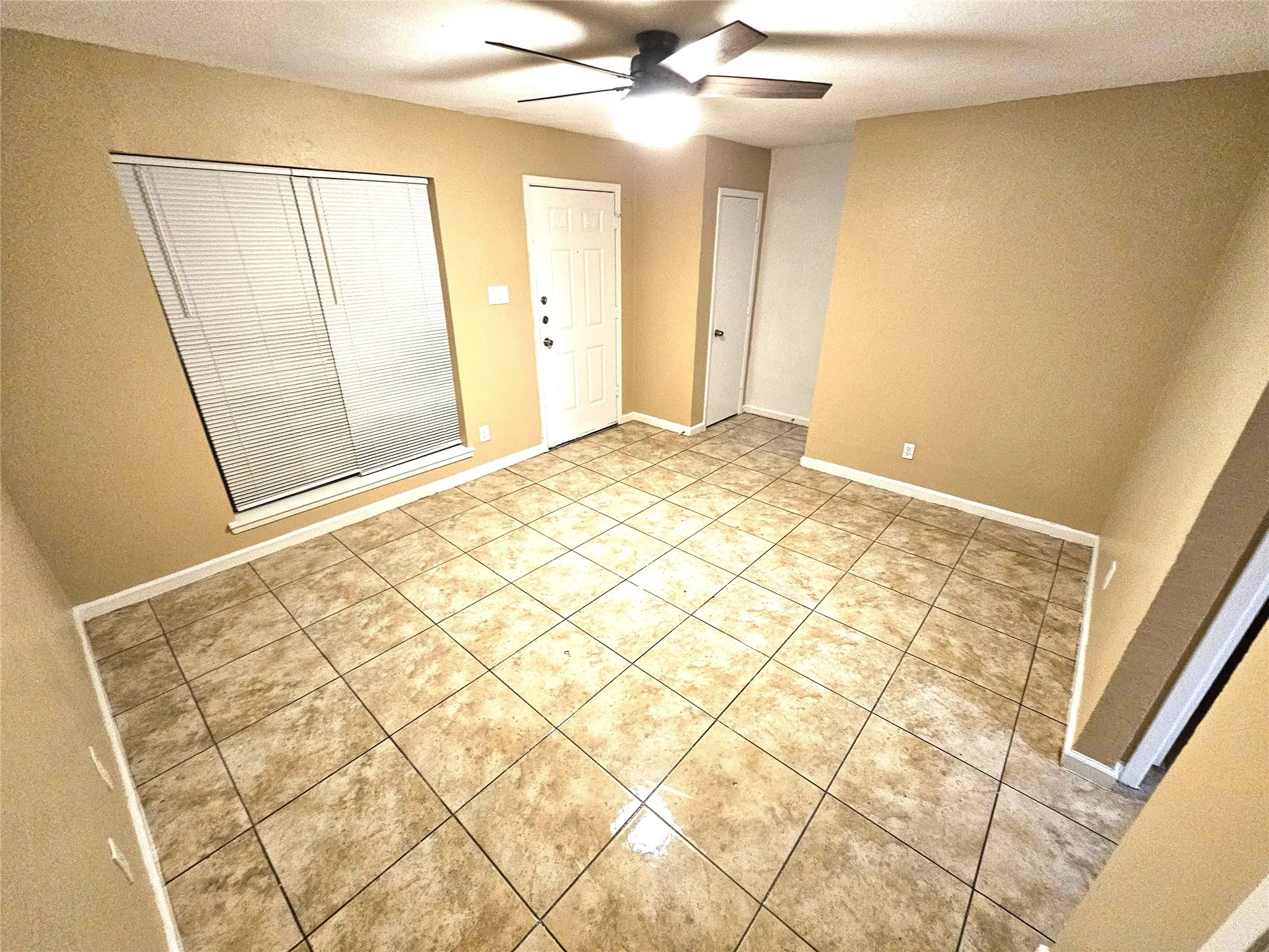 Family/Living room with new fresh paint and new ceiling fan. (unit D)