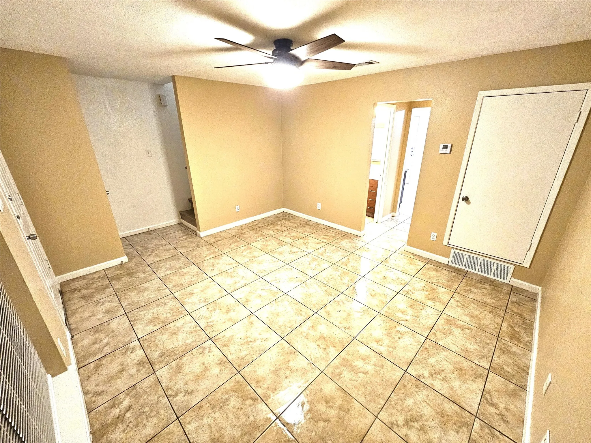 Family/Living room with new fresh paint and new ceiling fan. (unit D)