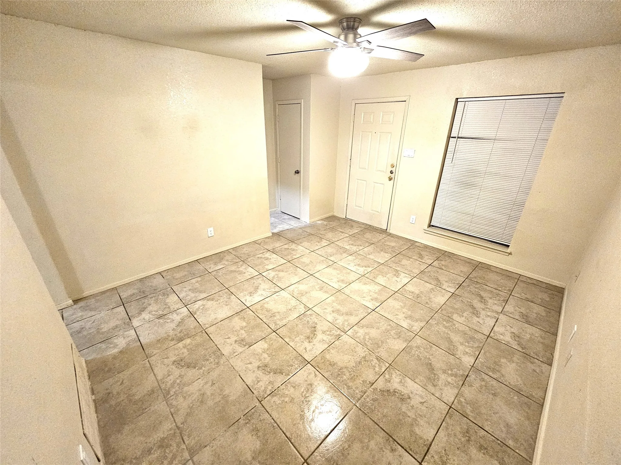 Family/Living room with new fresh paint and new ceiling fan. (unit B)