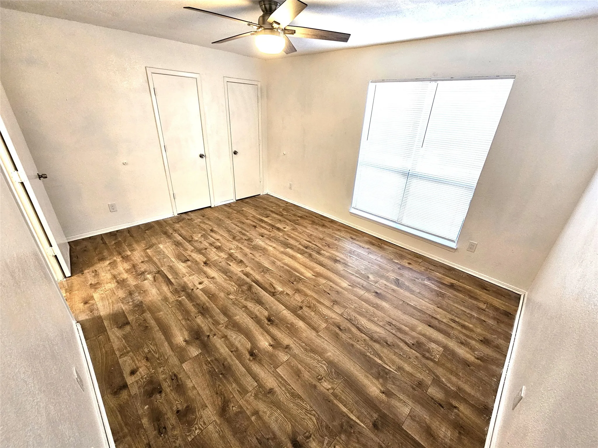 Bedroom #1-spacious bedroom (13x13) with new modern ceiling fan & wood laminate flooring - no carpet in this townhome. Stairs is wood laminate as well. (unit A)