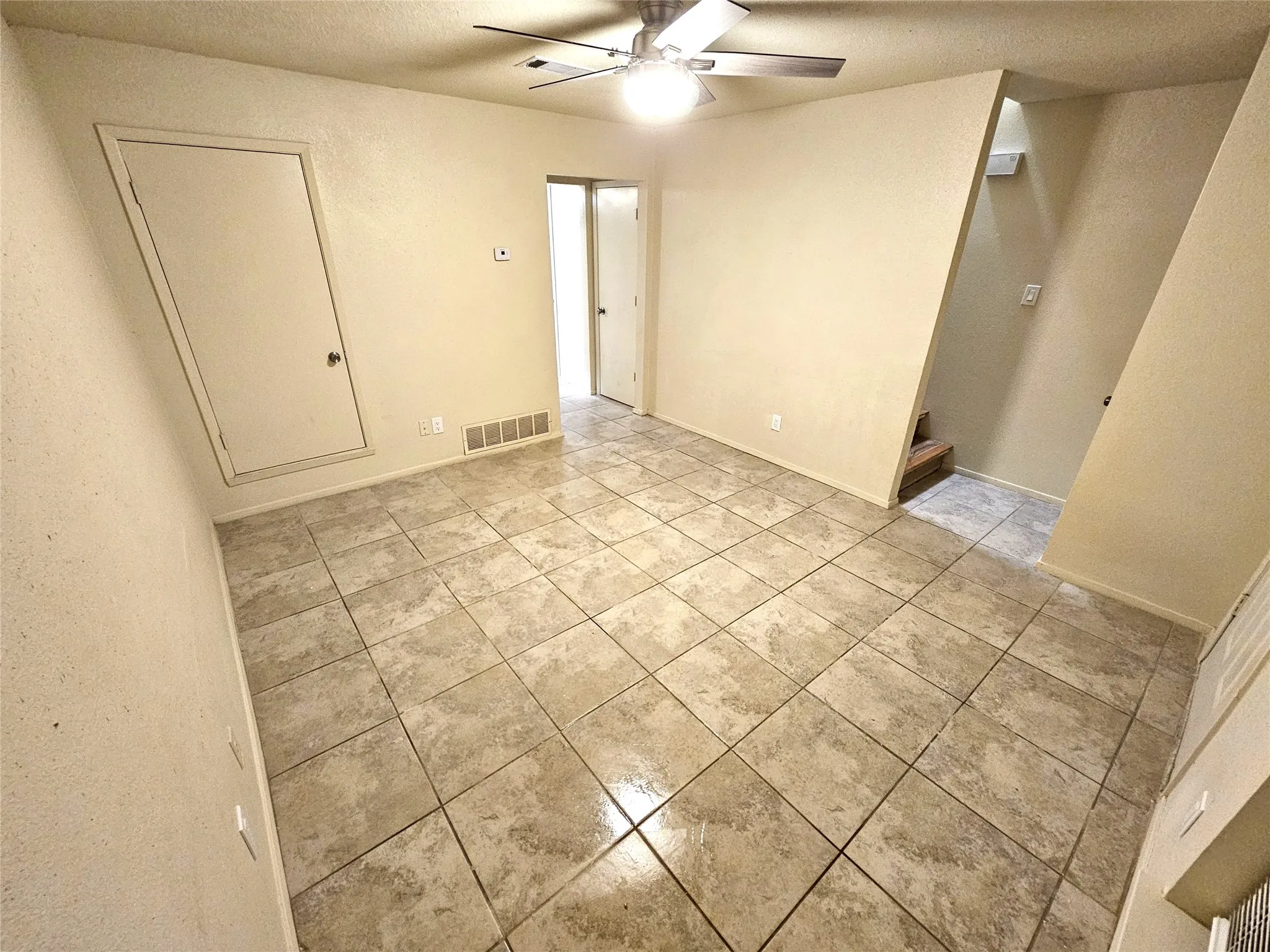 Family/Living room with new fresh paint and new ceiling fan. (unit B)
