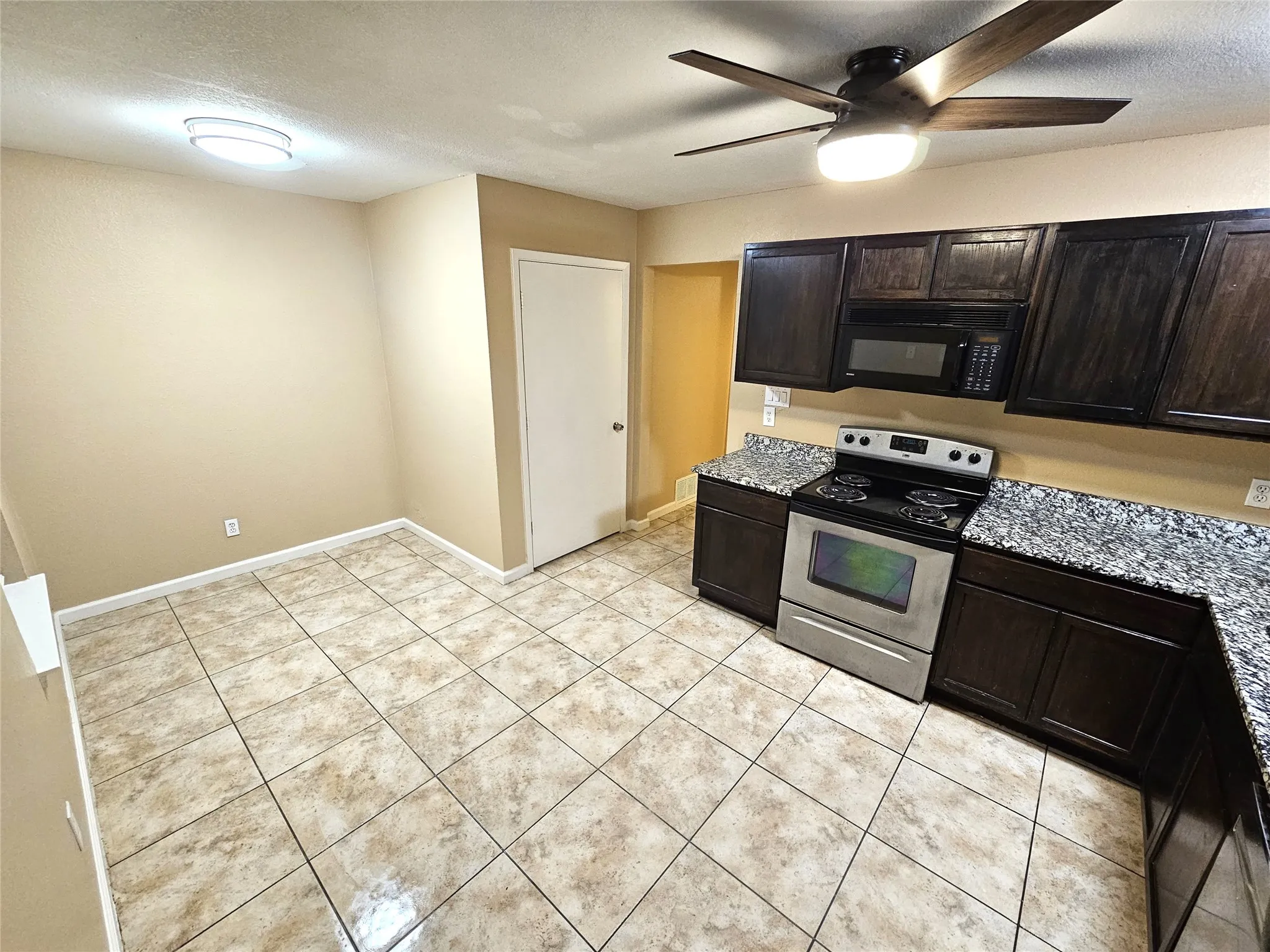 Newlly remodeled kitchen with lots of newly installed cabinets, new modern ceiling fan, modern light. New sink and faucet, new cabinets, granite countertop. new appliances. (unit D)