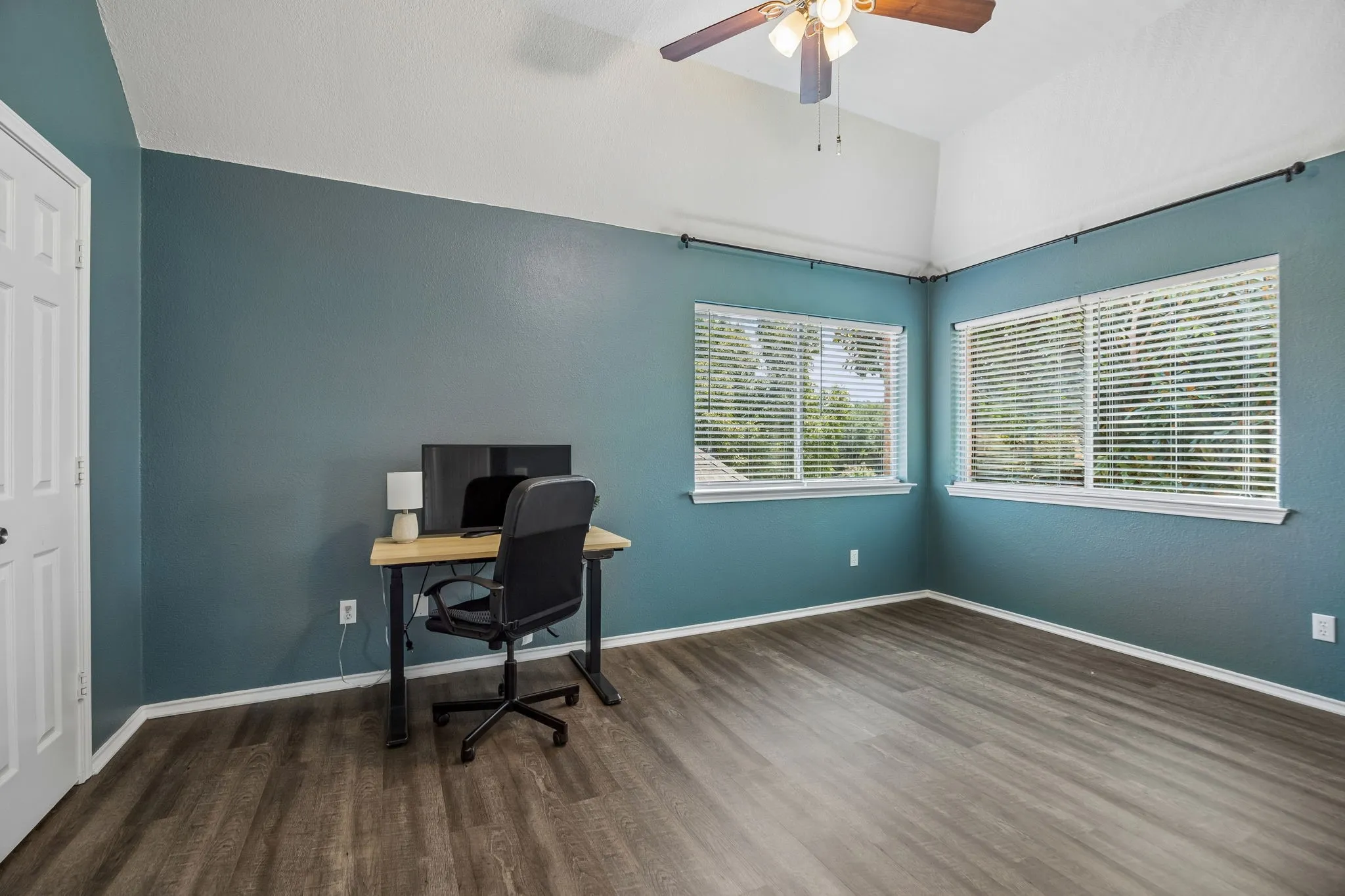 Large sized bedroom currently being used as an office.