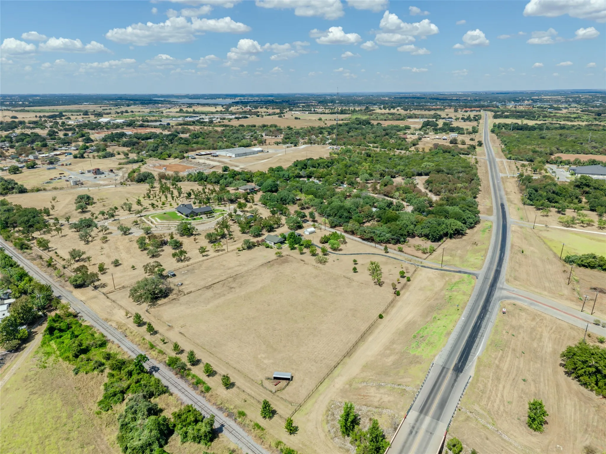 Expansive rural landscape with a primary road, secondary road, and a railroad line