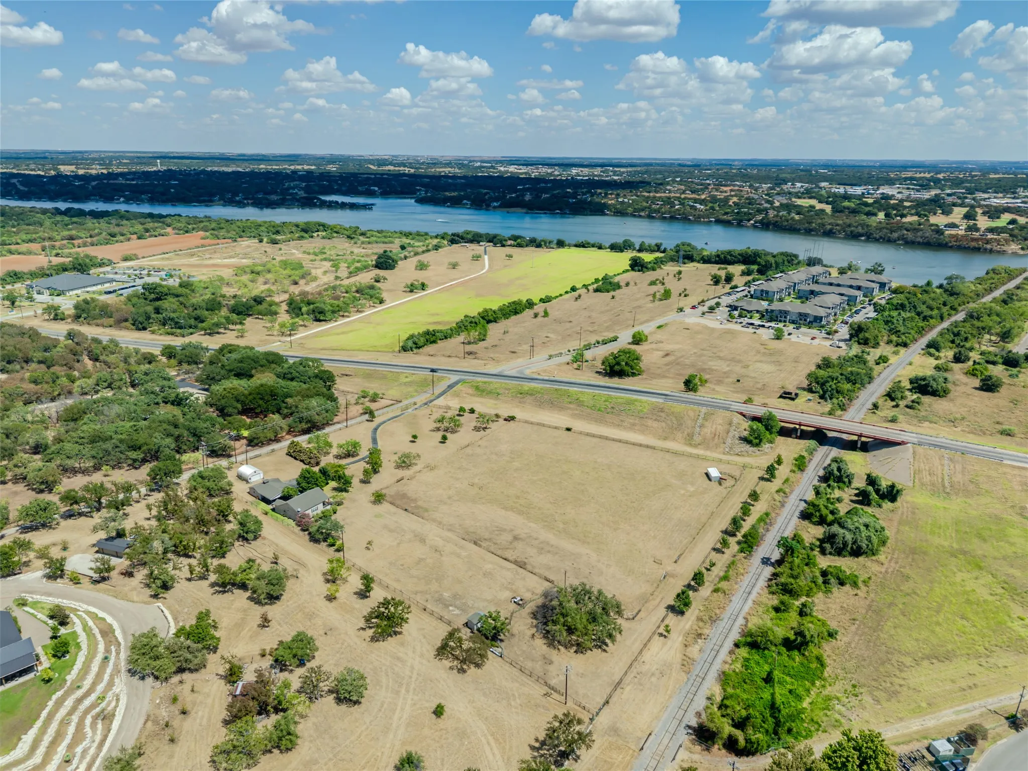 Expansive land parcel with surrounding foliage and multiple access roads