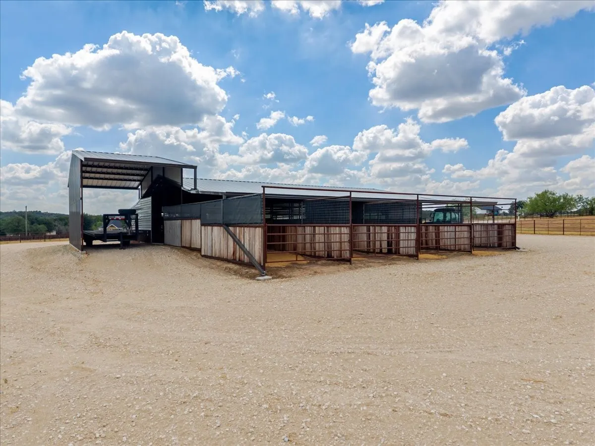 Barn exterior with covered tractor/equipment parking