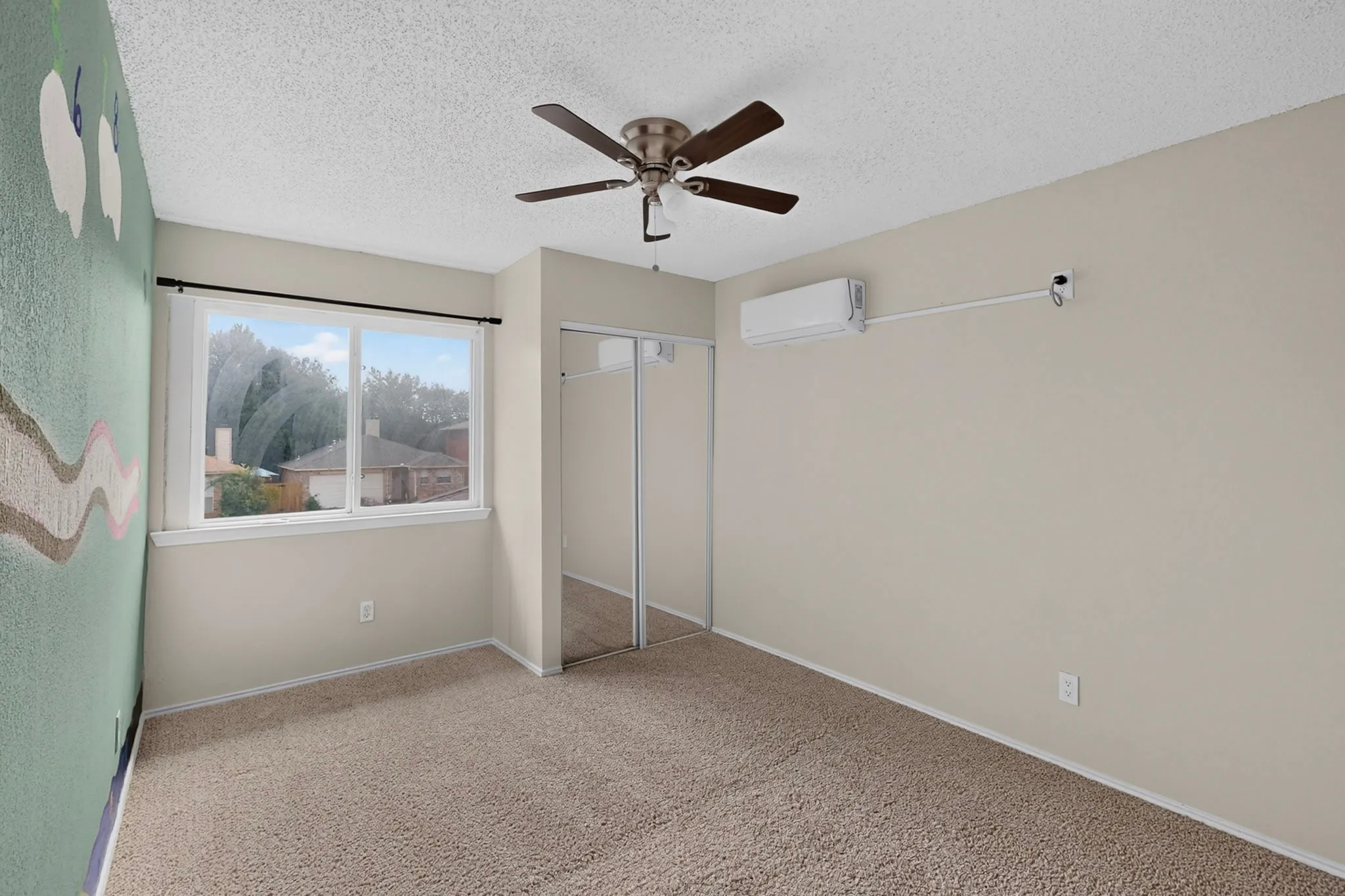 Wall-to-wall carpeting, ceiling fan, dual sliding mirrored closet doors, and window unit