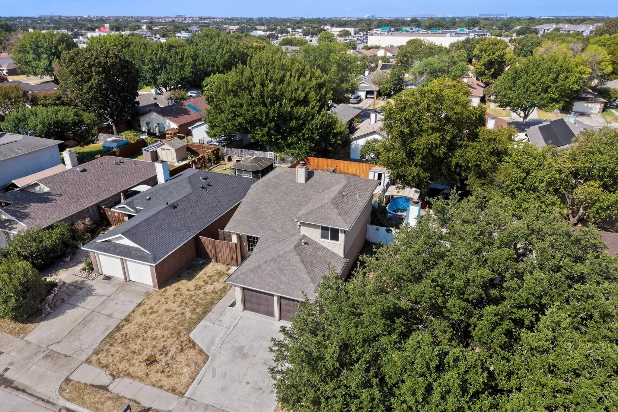 Suburban residence featuring a two-car garage, pitched roofline, and established neighborhood setting