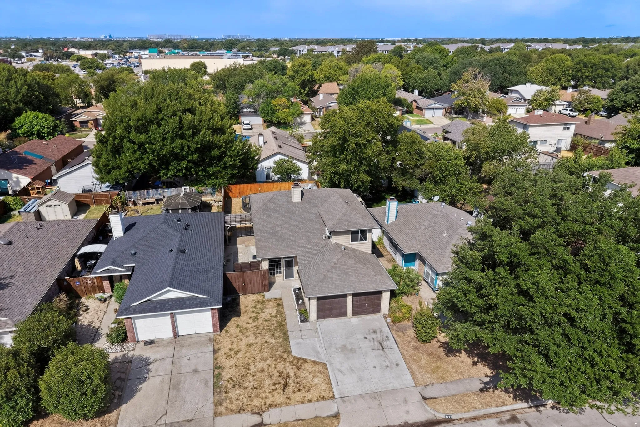 Aerial perspective showcasing two properties with attached garages