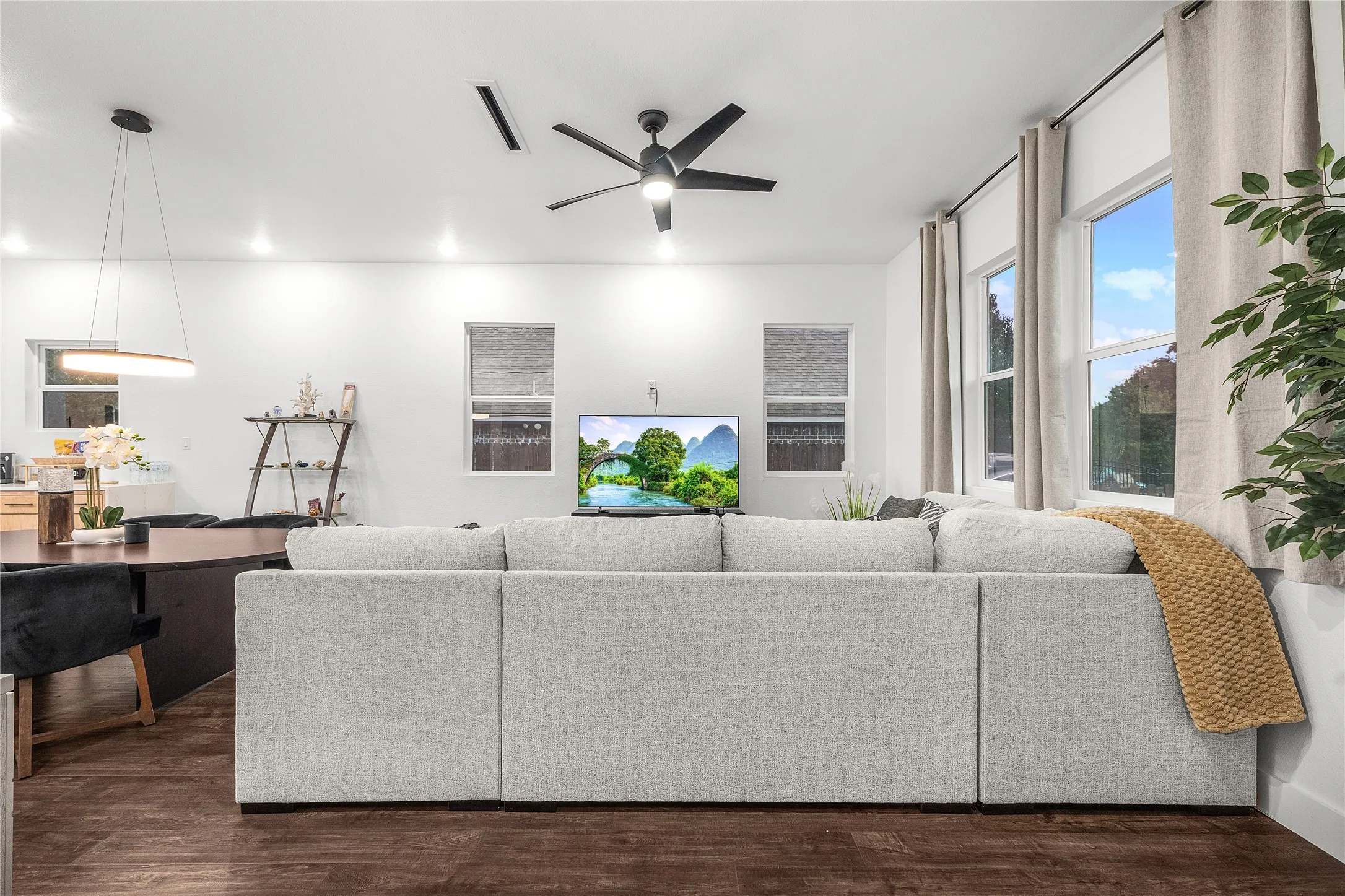 Wood-finish flooring, recessed lighting, and a contemporary ceiling fan