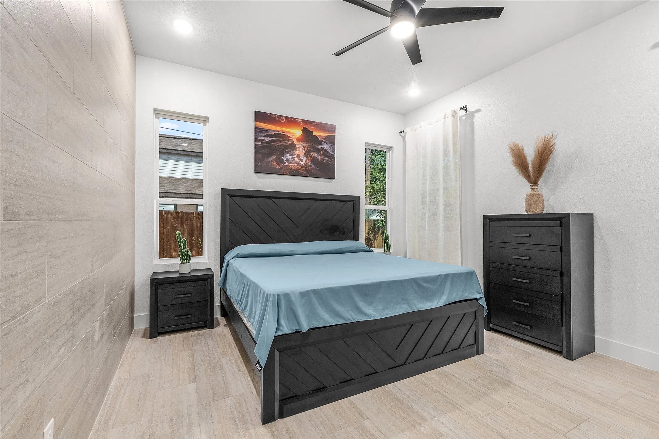 Recessed lighting, ceiling fan, and light wood-finish flooring