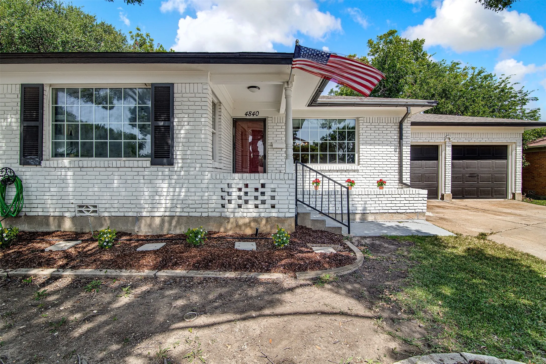 White painted brick exterior with dark trim