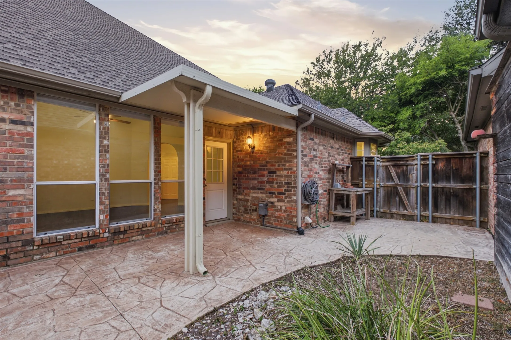 Covered patio steps from the living room — shaded outdoor living you'll use nine months a year