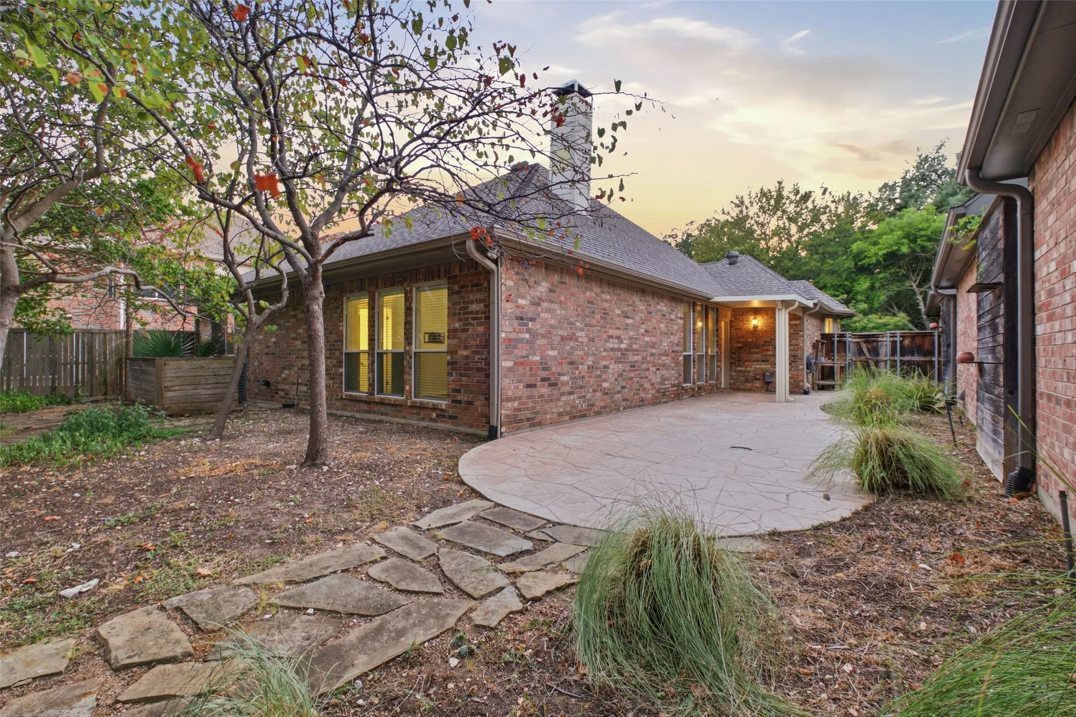 Covered patio steps from the living room — shaded outdoor living you'll use nine months a year