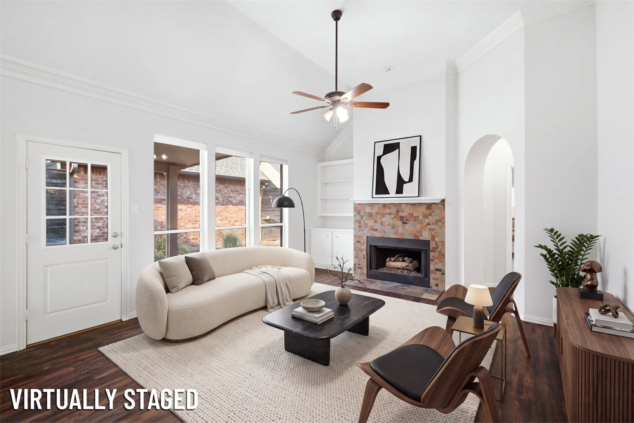 (Virtually Staged) Wall of windows to the patio and a fireplace that anchors the room — light all day, warmth all winter
