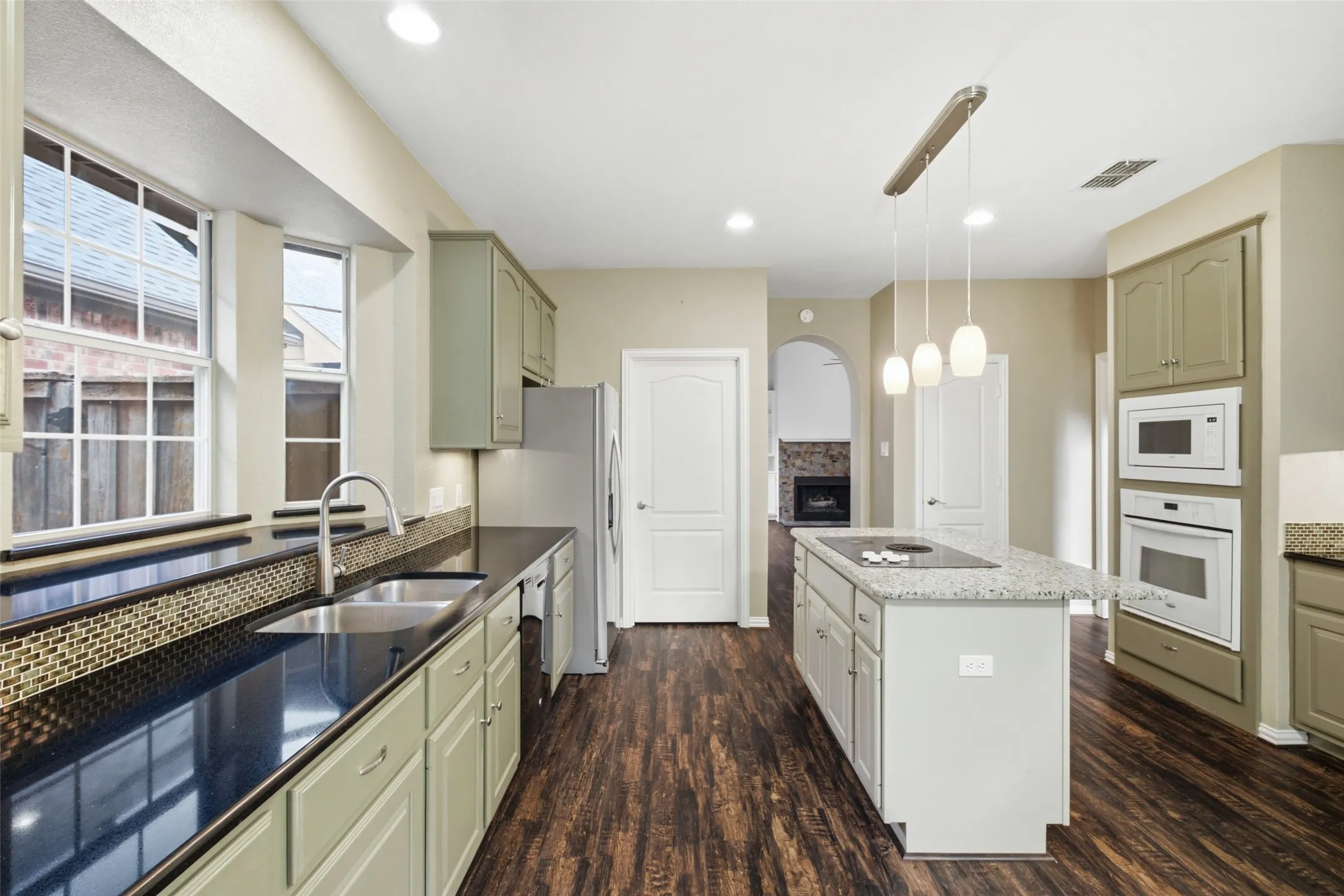 Stand at the sink and still see the fireplace — the cook is never stuck in another room