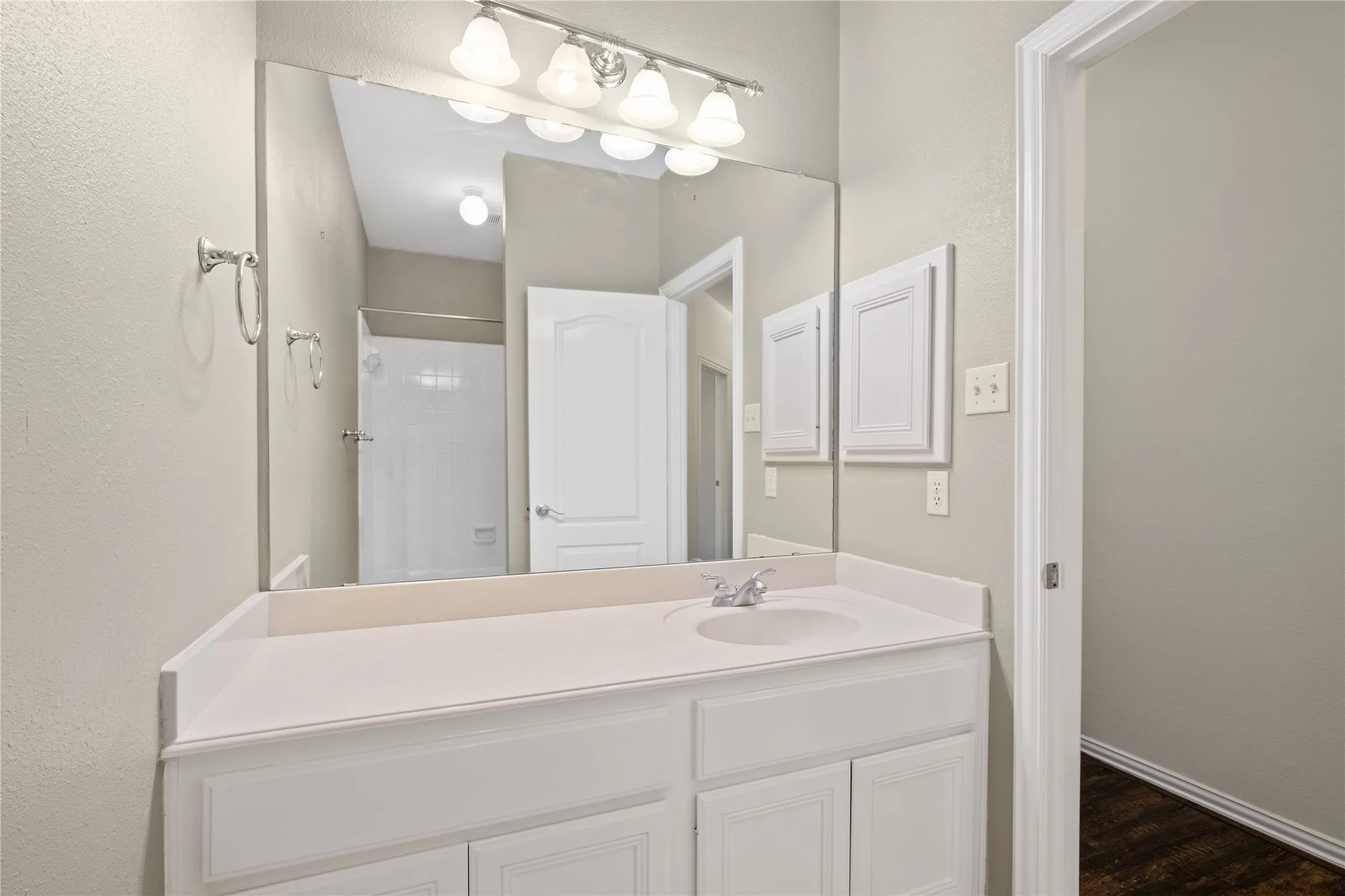 Secondary bath with an extra-long vanity and full-width mirror