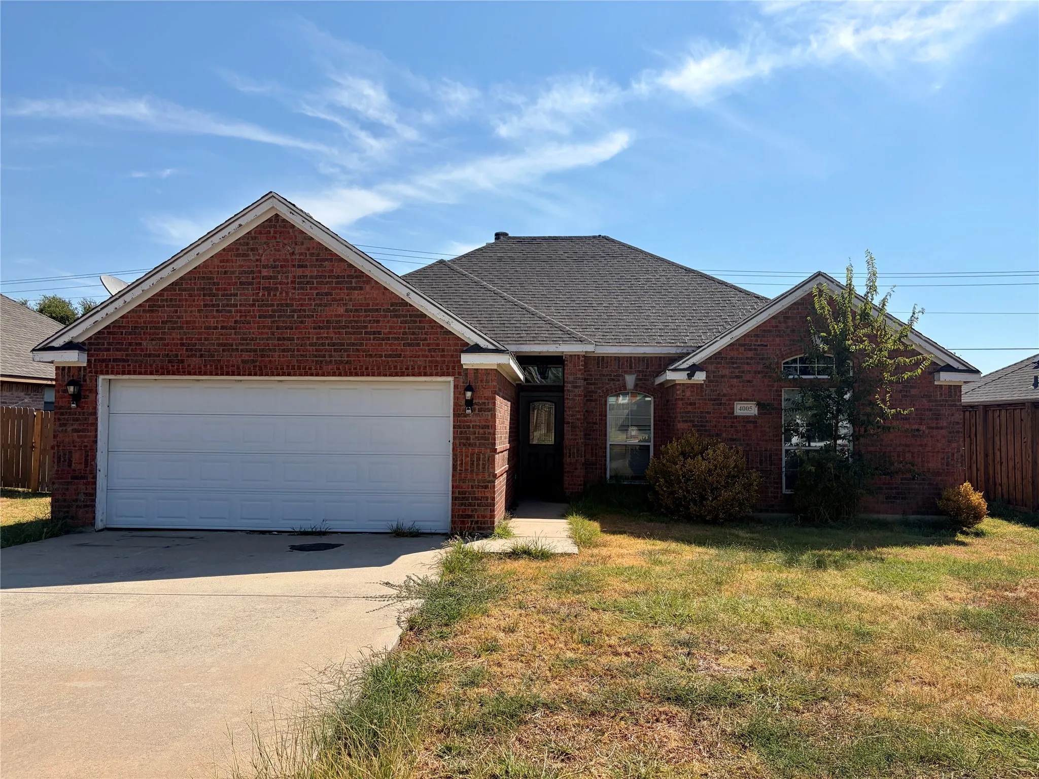 Brick exterior with a gabled roof and attached garage