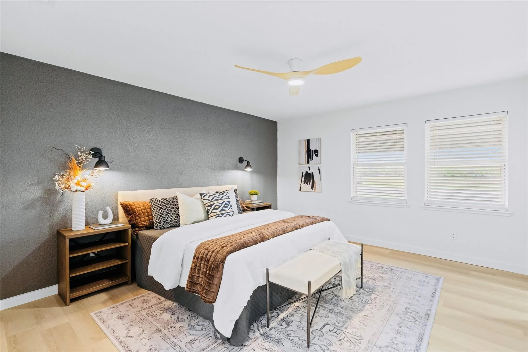 Recessed lighting, wood-finish flooring, accent wall, ceiling fan, and two windows with blinds