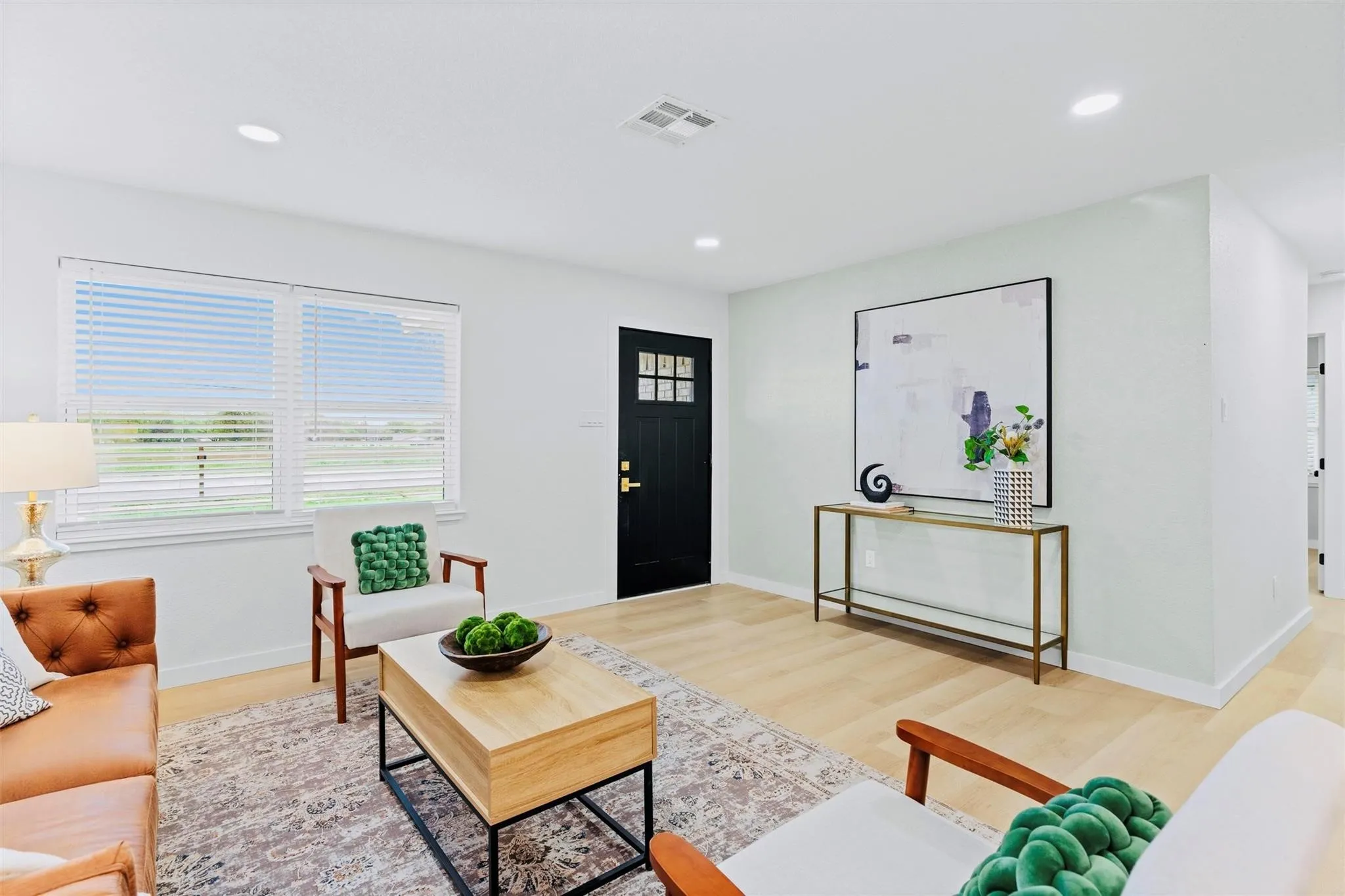 Recessed lighting illuminates wood-finish flooring