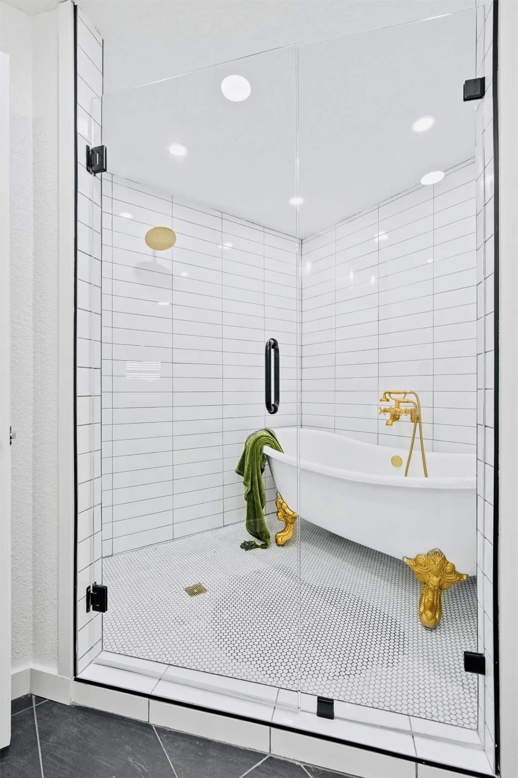 Glass-enclosed wet room with white subway tile walls