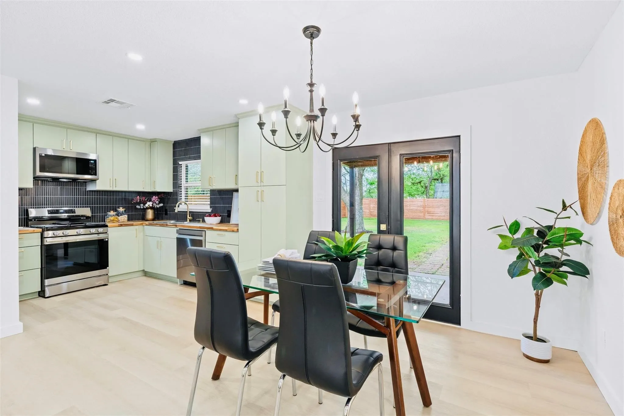 Light wood-finish flooring, recessed lighting, and a chandelier