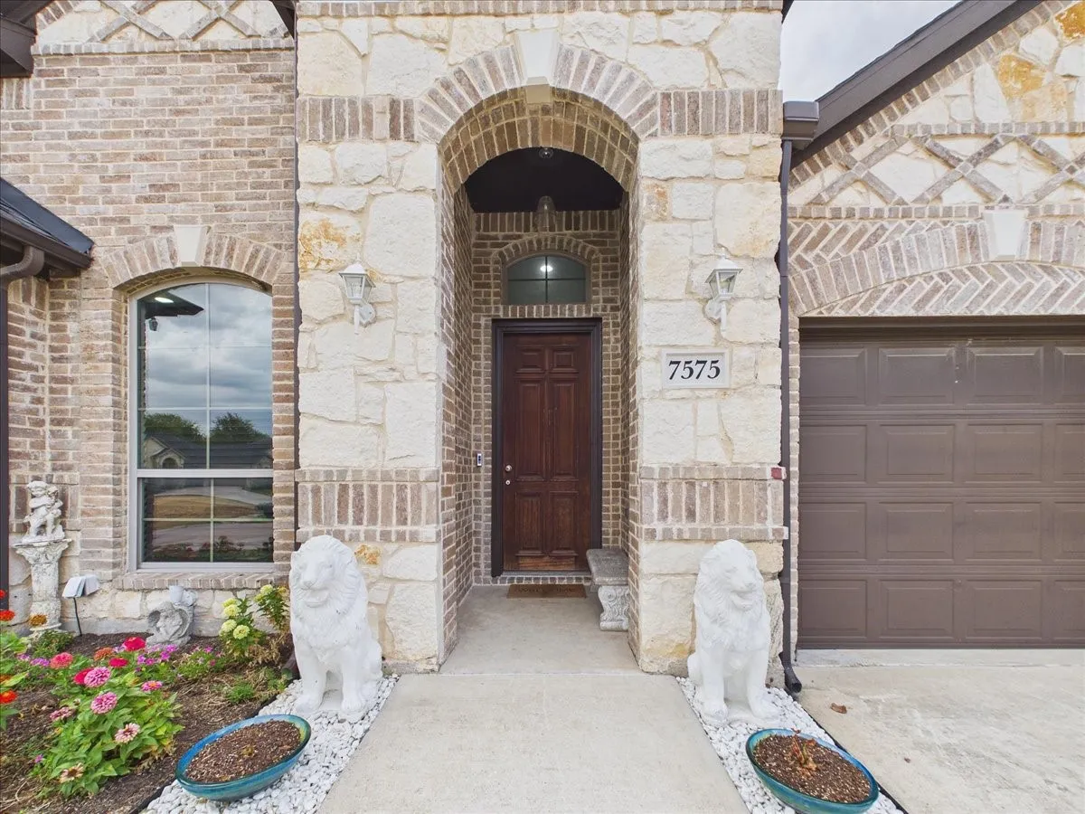 Brick and stone facade with arched entry