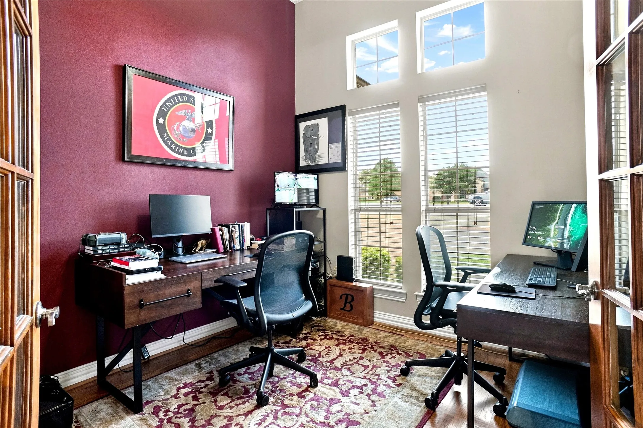 High ceilings with transom windows, wood-finish flooring, and French doors