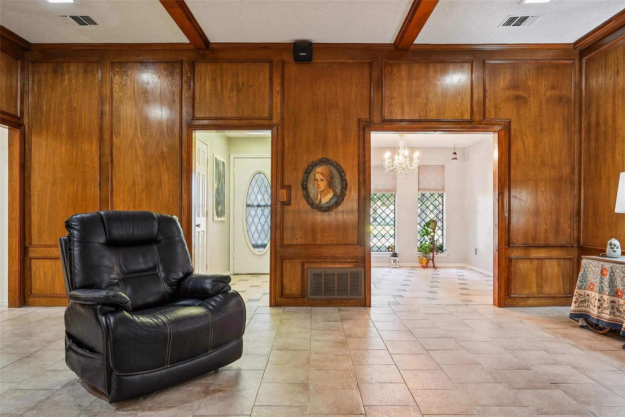 Wood paneling with trim accents, recessed lighting, and tiled flooring