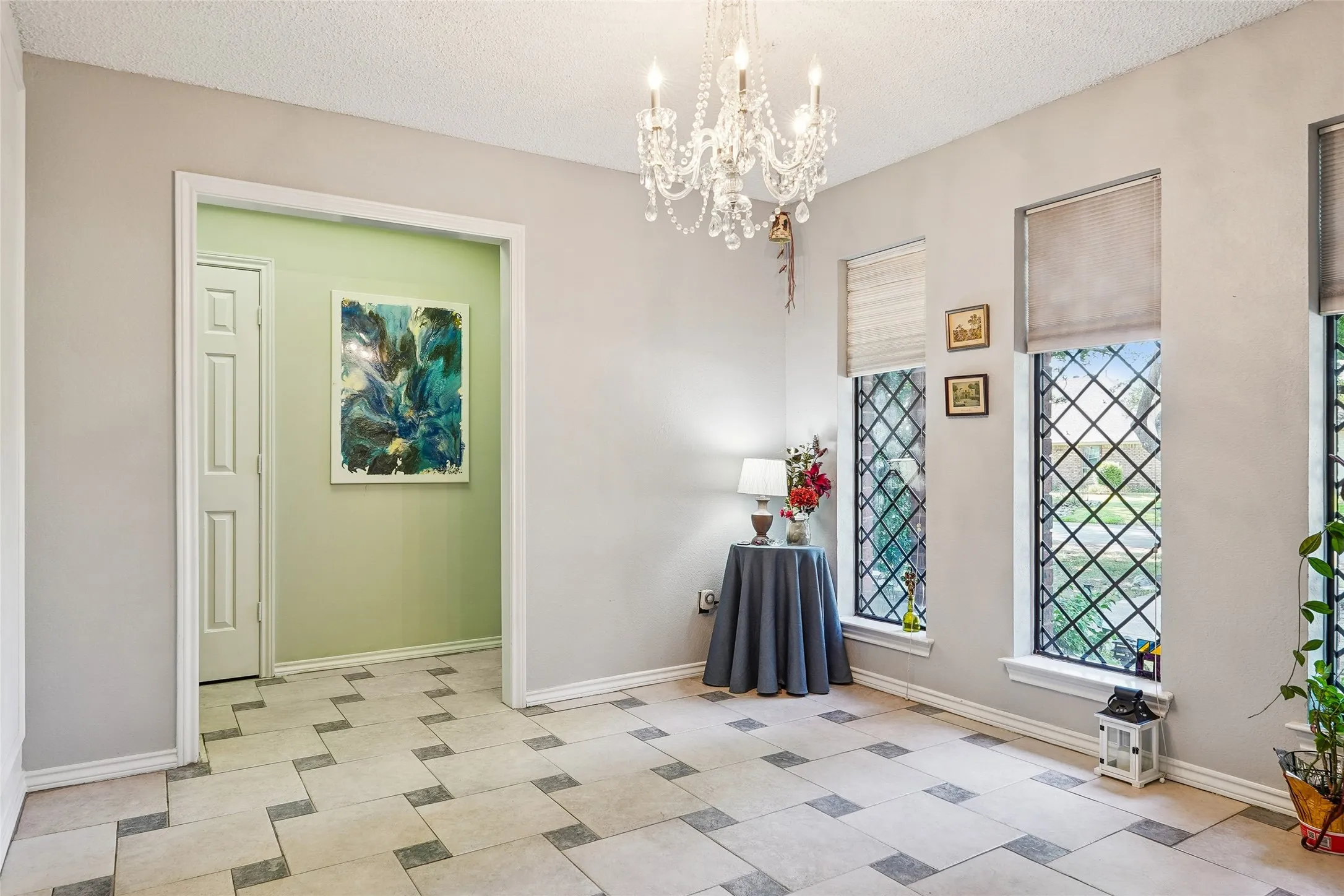 Decorative chandelier with crystal accents, paired with patterned floor tiles