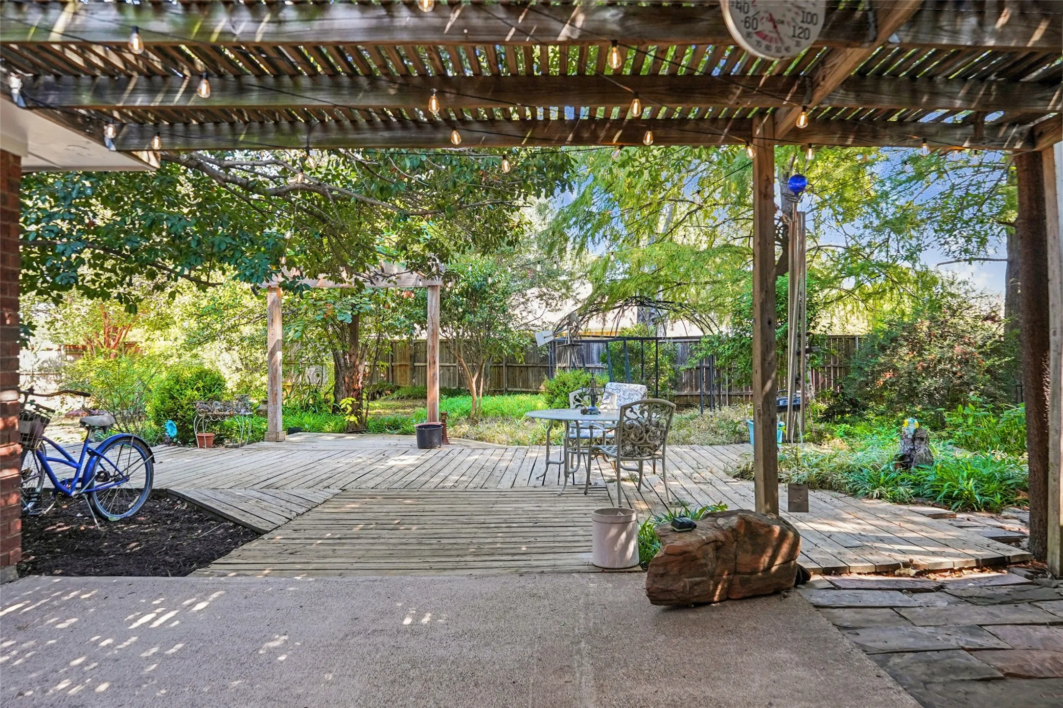 Wood pergola with integrated string lighting over a concrete patio