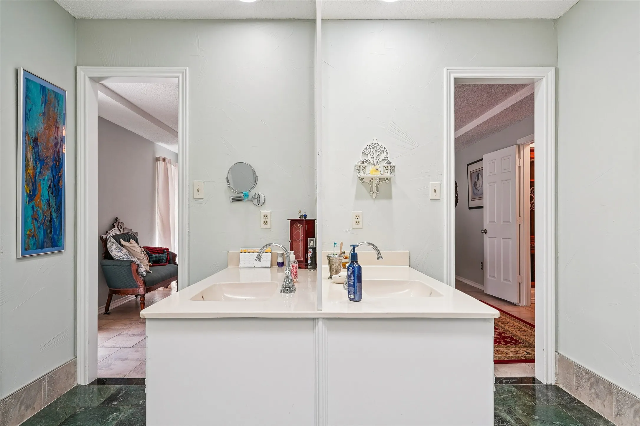 Dual vanity with integrated sinks, light-toned countertop, and undermount cabinetry