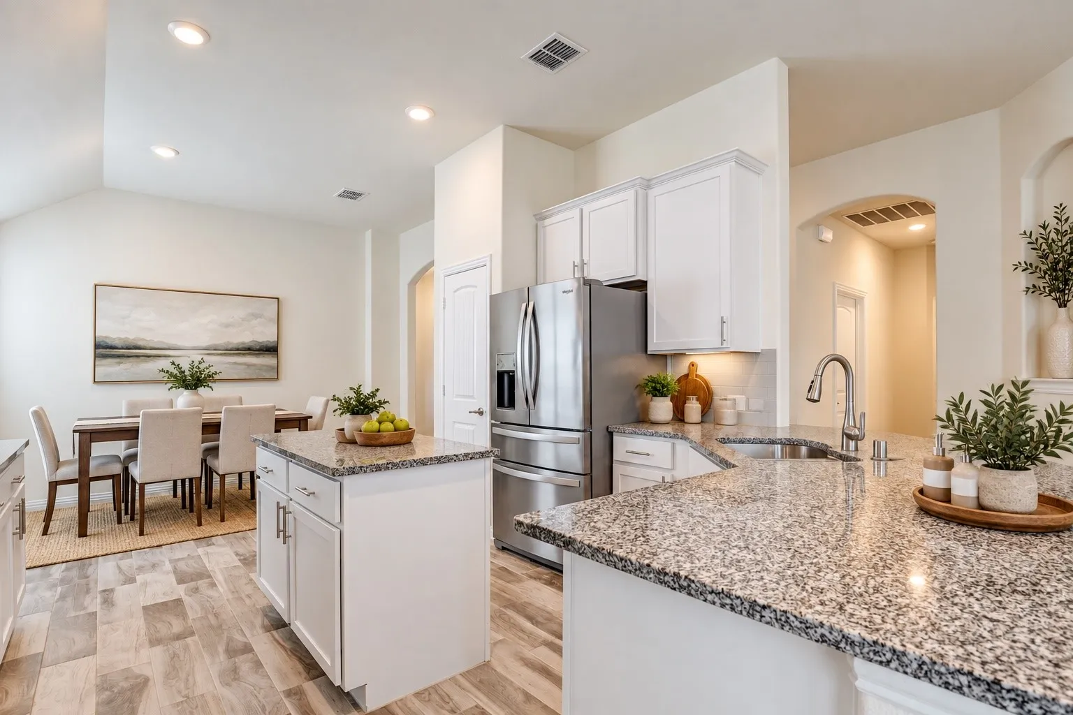 Kitchen featuring granite countertops, white cabinetry, stainless steel appliances, and a tile backsplash