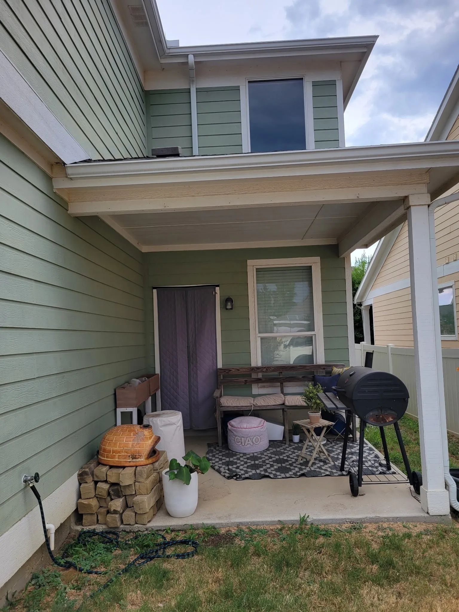 Covered concrete patio with a hose bib