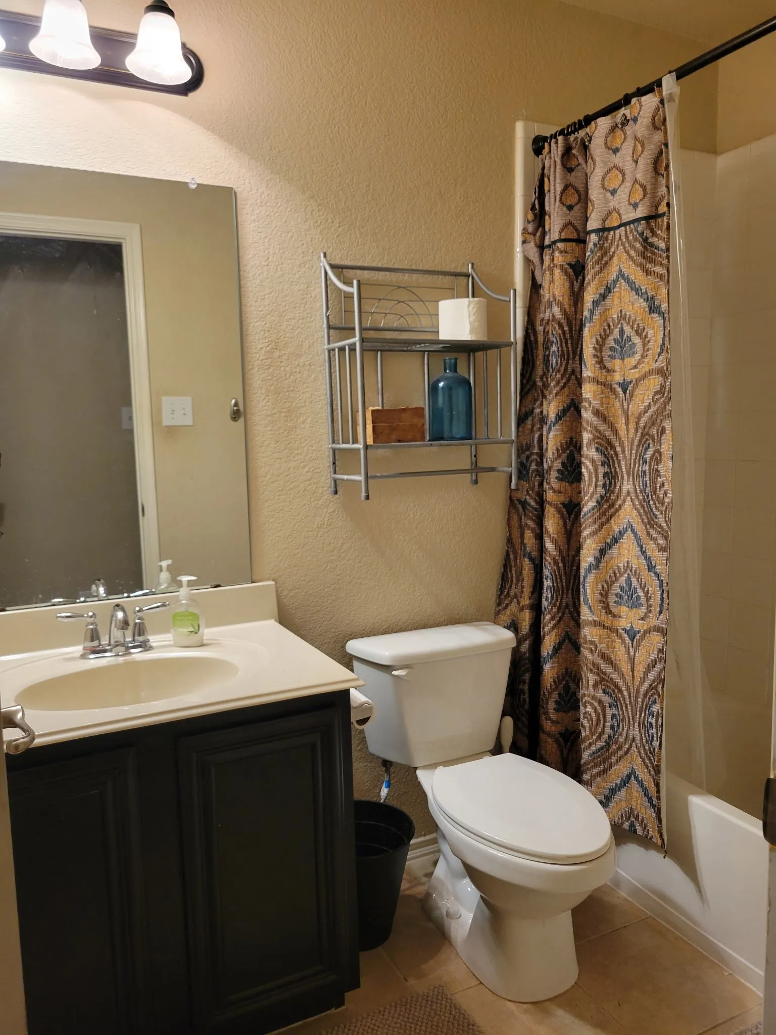 Vanity with inset panel cabinetry, undermount sink, and chrome faucet