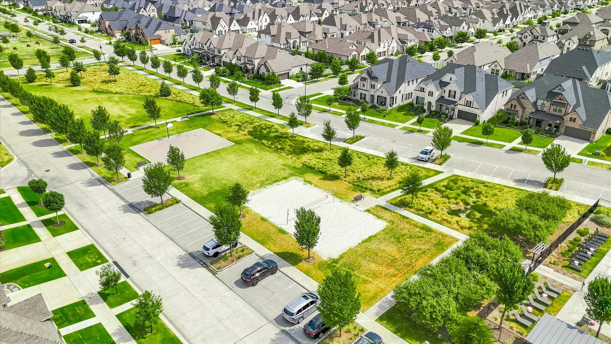 Expansive green spaces with manicured lawns, paved walkways, and mature trees