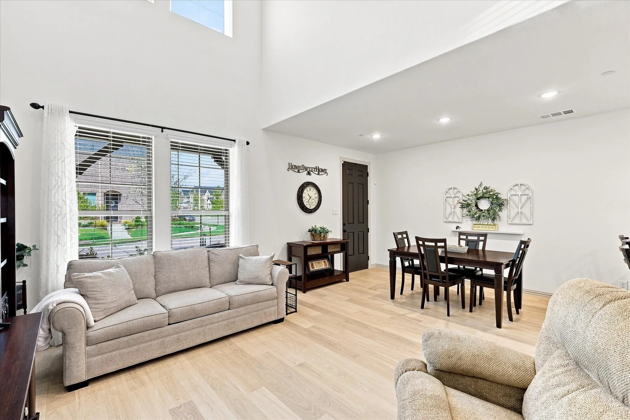 Soaring ceiling height, light wood-finish flooring, recessed lighting, and large windows with blinds are just a few of the benefits.