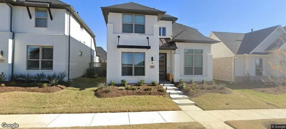 White stucco exterior with dark trim accents