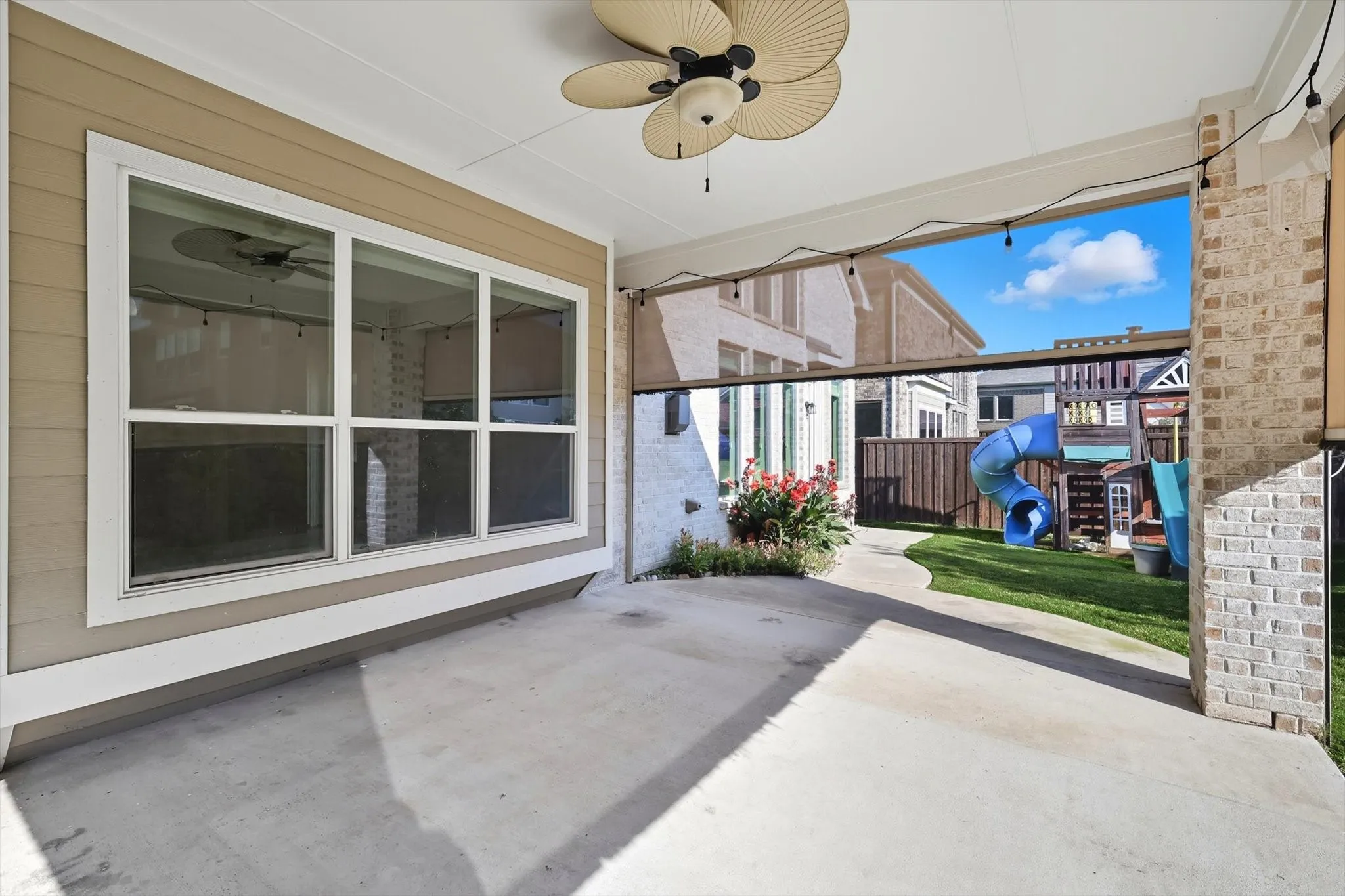 View of patio featuring a ceiling fan and a playground